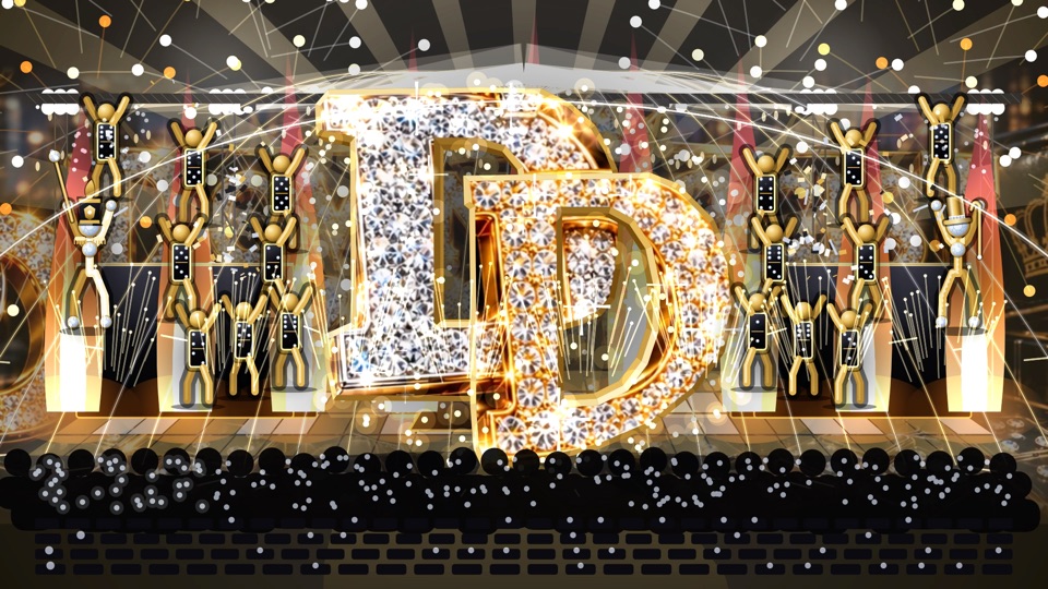 The halftime show's drop: a giant diamond DD lands on a stage between gold dancers holding dominoes, with sparks falling over the crowd.